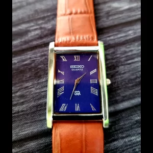 NOS Men's Silver Tank Blue Dial Brown Strap Dress Watch New Mvt Batt
